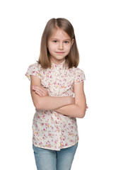 Serious little girl against the white background