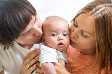 mother and father playing with cute baby son