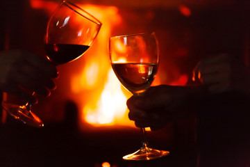 glass of  wine beside the fire
