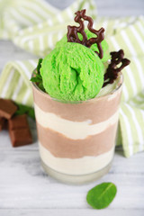 Tasty chocolate mousse with sorbet on wooden table