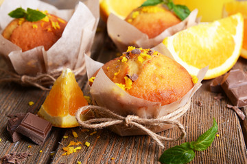 Tasty cupcakes with orange on table close-up