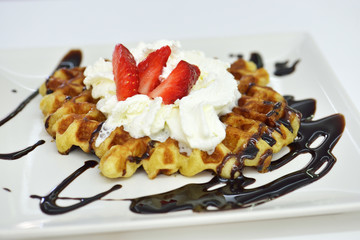 waffle with cream, strawberries and chocolate