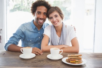 Obraz na płótnie Canvas Casual couple having coffee together
