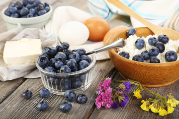 Fresh blueberries and milk products on wooden table