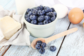 Fresh blueberries and milk products on wooden table