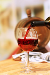 Red wine pouring into wine glass, close-up