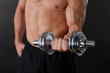 Muscle young sportsman execute exercise with dumbbell