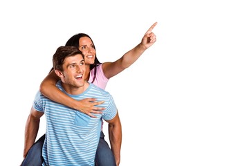 Young man giving girlfriend a piggyback ride