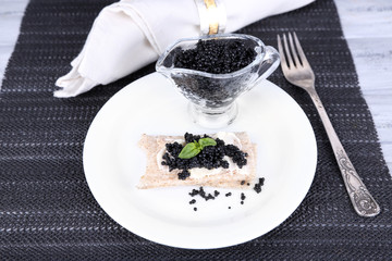 Slice of bread with butter and black caviar