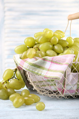 Ripe grapes in metal basket with napkin