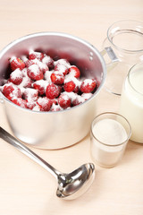 Cooking delicious strawberry jam in kitchen