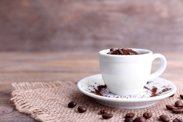 Mug of coffee beans and ground coffee