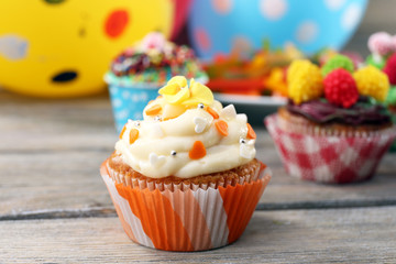 Delicious birthday cupcakes on table close-up