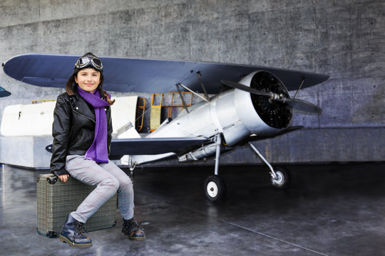 Plane, aviator- girl ready for travel around the world