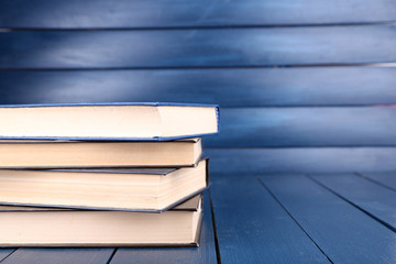 Books on dark blue wooden background