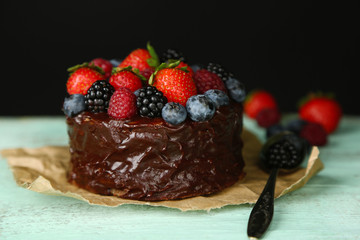 Tasty chocolate cake with different berries