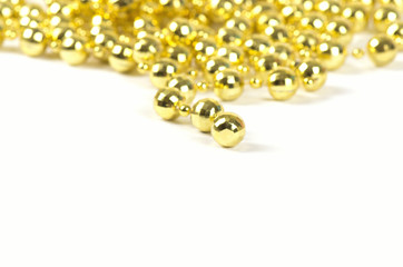 Background made of a brilliant celebratory beads of golden color