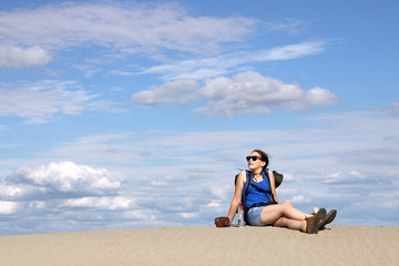 Fototapeta na wymiar girl hiker is resting in the desert