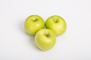 Three Granny Smith Apples on White Counter