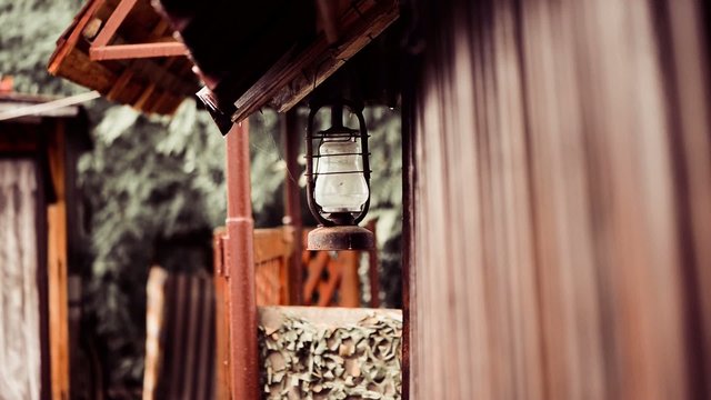old farm lamp on building corner at rainy day