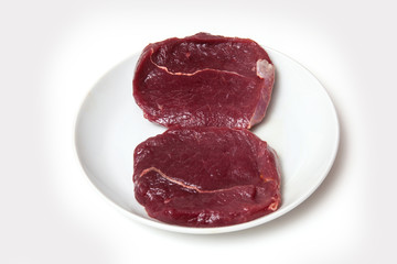 Zebra steaks isolated on a white studio background,