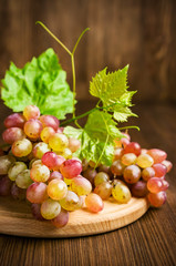 ripe pink grapes with leaves