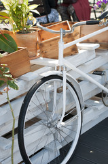 Vintage decoration bicycle standing  near wooden boxes.