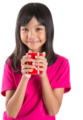 Young Asian preteen girl with a red mug over white background