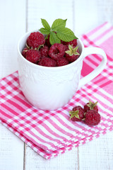 raspberries in white cup