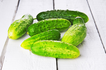 Ripe cucumbers on wooden backdrop