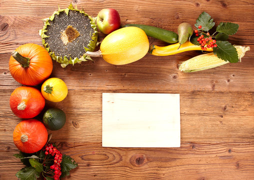 autumn background with pumpkin on wooden board
