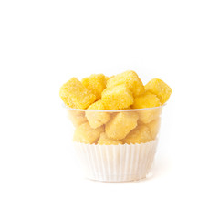 baking biscuit covered by sugar and cheese in plastic cup