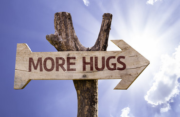 More Hugs wooden sign on a beautiful day