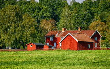 red farm and nature set in a swedish landscape