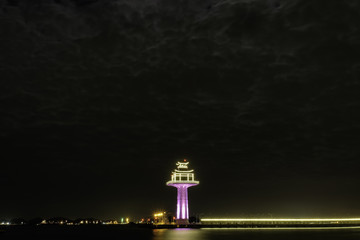 Fototapeta na wymiar night time view of lighthouse in the sea at Si Chang island, Tha