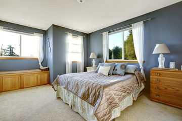 Bedroom interior with navy walls and queen bed
