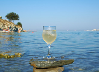 Glass of white wine by the coast