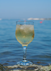 Glass of white wine by the coast