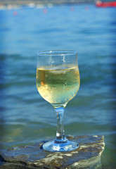 Glass of white wine by the coast