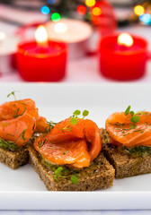 Delicious appetizer canapes of black bread with smoked salmon