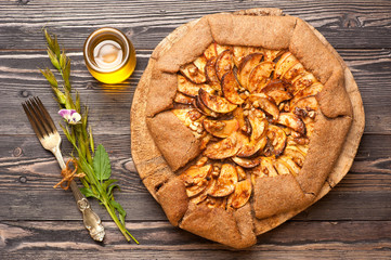 Galette with apples, nuts and honey. Apple pie. Crostata.