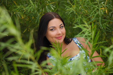 sexy young woman in dress in the grass