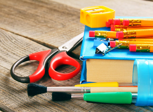 School tools. On wooden background.