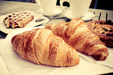 Breakfast with coffee and croissants
