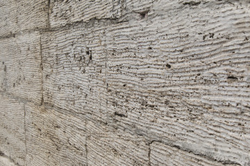 Textured wall of limestone blocks, background