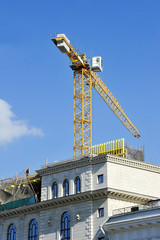 Fototapeta na wymiar crane construction completes attic
