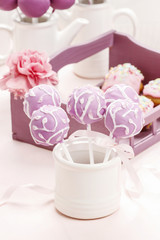 Fototapeta na wymiar Lilac cake pops lavishly decorated with icing.