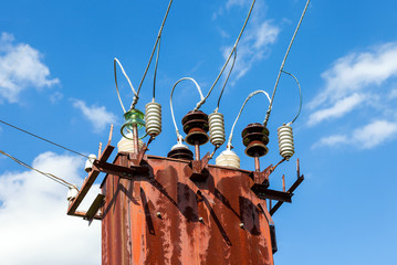 Power transformer against the blue sky background
