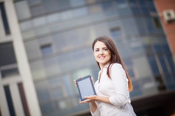 Happy business woman using a tablet computer