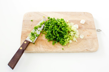 Spring onion on a cutting board with knife
